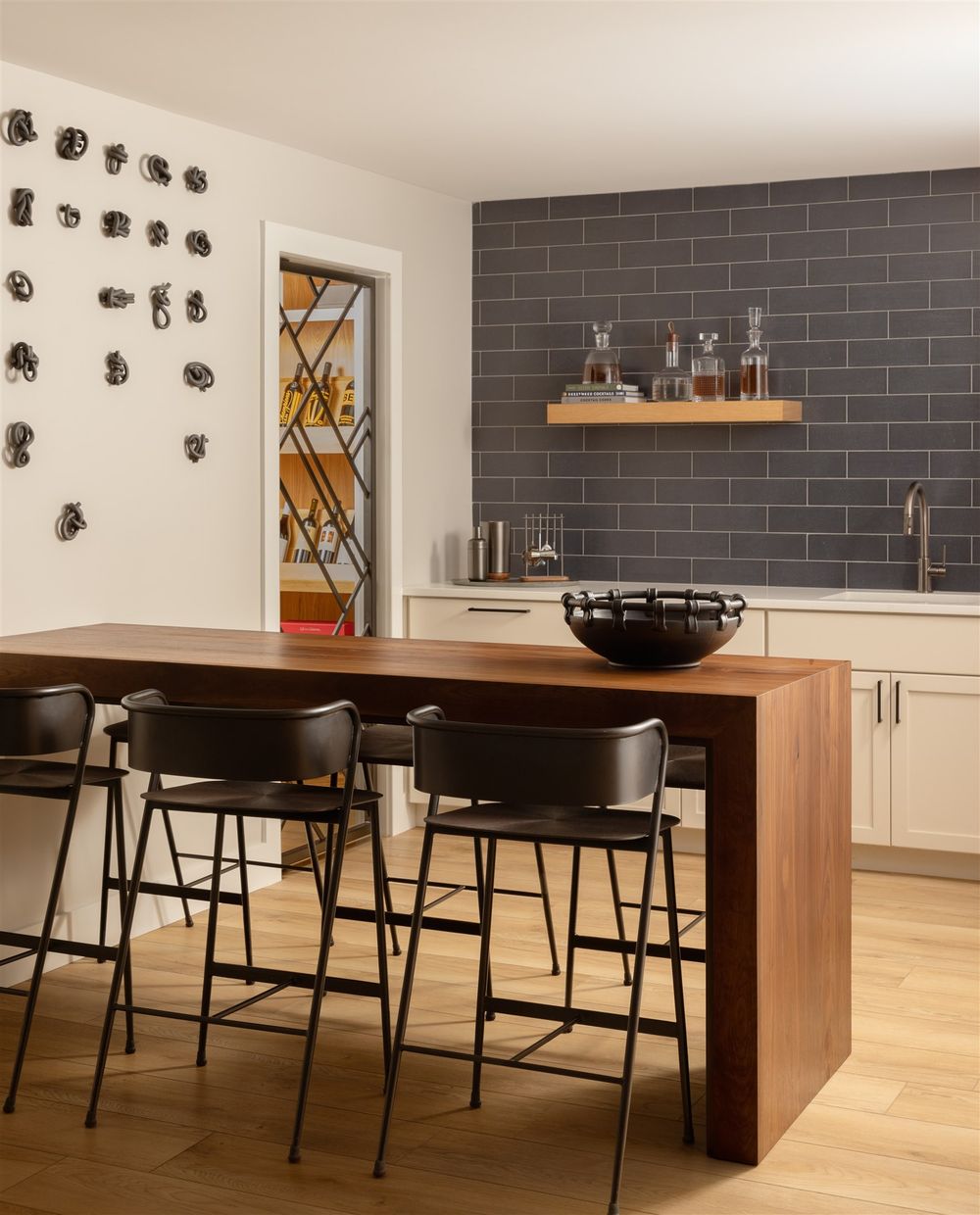 Walnut waterfall bar and steel wine room door